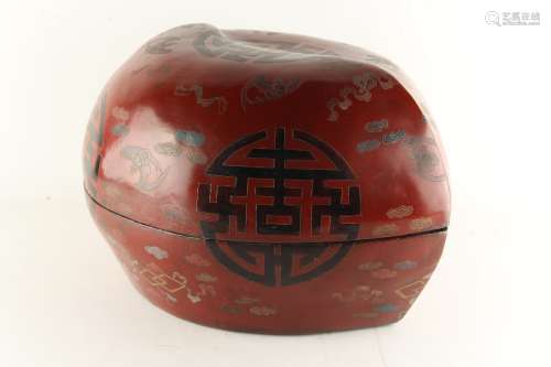A large Chinese lacquer peach shaped box, decorated with shou characters, bats & precious objects,