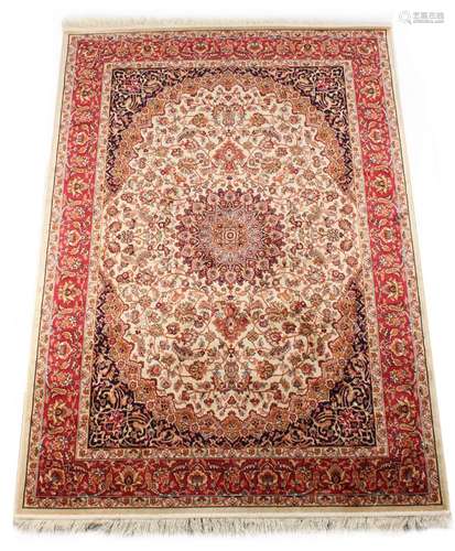 A Kashan style rug with ivory ground, 75 by 53ins. (190 by 135cms.) (see illustration).