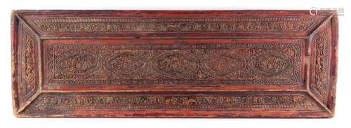 A Tibetan carved gilt & red painted wood rectangular book cover, 19th century or earlier, 28.35 by