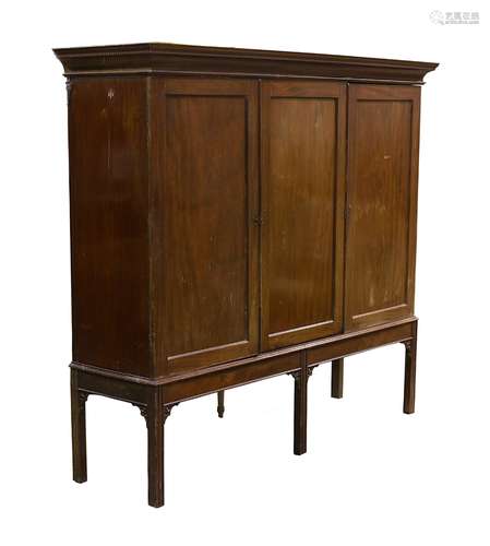 Property of a gentleman - a 19th century mahogany three-door linen press cupboard, on later