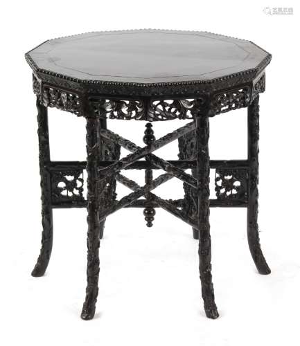 A late 19th / early 20th century Chinese carved hongmu dodecahedral table with folding six legged