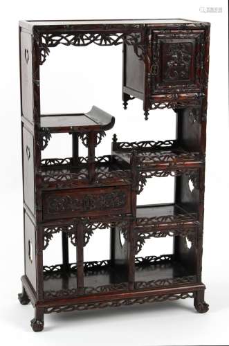 A late 19th century Chinese carved hongmu display cabinet of small size, fitted with a door, a