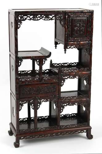 A late 19th century Chinese carved hongmu display cabinet of small size, fitted with a door, a