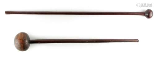 Two Zulu tribal knobkerries, circa 1900, with globular heads, 31.5ins. (80cms.) and 26.55ins. (67.