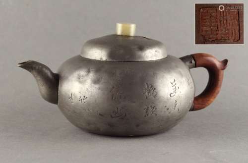 A 19th century Chinese pewter teapot with incised flowers & calligraphy, the cover with pale celadon