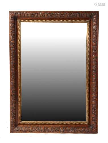 Property of a gentleman - a carved oak rectangular framed wall mirror, 34.85 by 25.3ins. (88.5 by