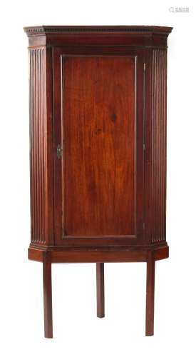 Property of a gentleman - a George III mahogany single door corner wall cabinet, with dentil