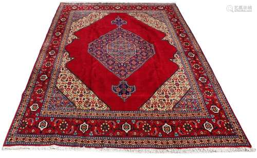 A Tabriz woollen hand-made carpet with red ground, 152 by 118ins. (385 by 300cms.) (see