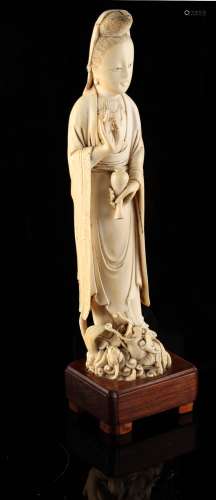 A 19th century Chinese carved ivory figure of Guanyin, modelled standing on a dragon & holding a