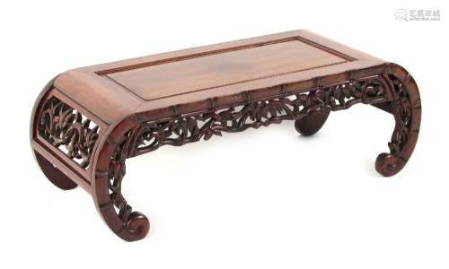 A Chinese hongmu kang table, carved & pierced to simulate bamboo, 38ins. (96.5cms.) long (see