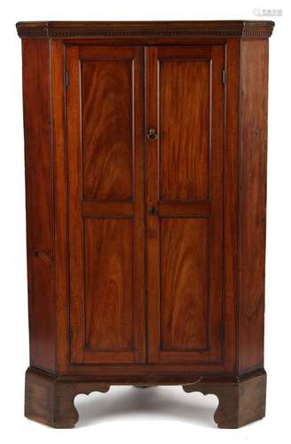 Property of a deceased estate - a George III mahogany panelled two-door corner cabinet, on bracket