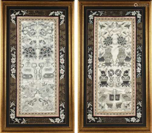 A pair of Chinese embroidered silk panels, one depicting vases of flowers & precious objects, the