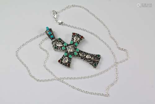 A Silver and Turquoise Cross Pendant