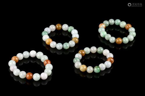 GROUP OF FOUR JADEITE ROUND BEADS BRACELETS