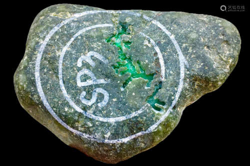 A BURMESE GREEN JADEITE STONE, A CLASS