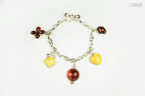 A Silver Lariat Bracelet with Various Amber Charms