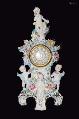 A Continental Porcelain Clock Covered with Flowers and with Four Cherubs