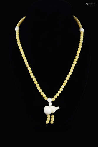 A Golden Streak Tridacna Bead Necklace with a Calabash Shape Pendant