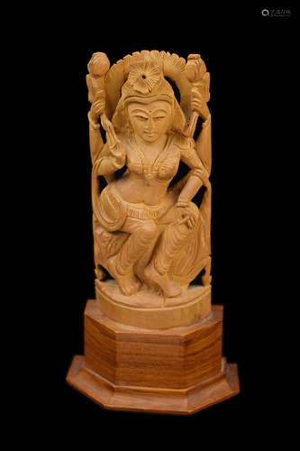 A Sandalwood Carved Four-Armed Guanyin Figure