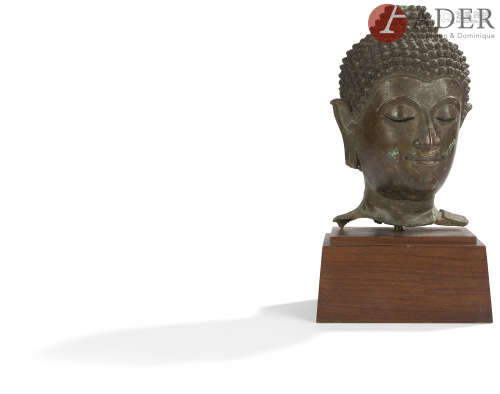 THAÏLANDE - XVIIe siècle Tête de bouddha en bronze à patine brune, les yeux entrouverts,