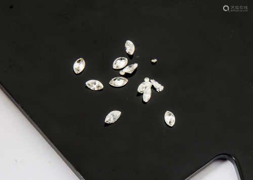 Ten loose marquise cut diamonds, total weight 1.28ct, (weighed) together with a few diamond chips