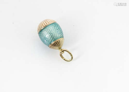 A Russian Henrik Wigstrom gold and enamel egg, the guilloche green body with ribbed lower and