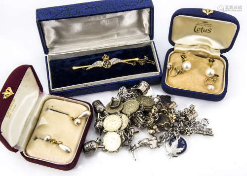A collection of jewellery, including three charm bracelets and a coin example, an RAF sweetheart
