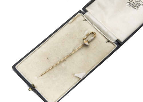 A late 19th Century yellow metal and enamel American stick pin, modelled as a military dress sword