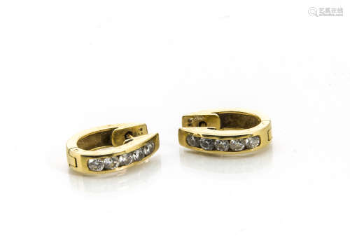 A pair of diamond and gold 750 marked channel set cuff earrings, the five brilliant cuts each 0.7ct,