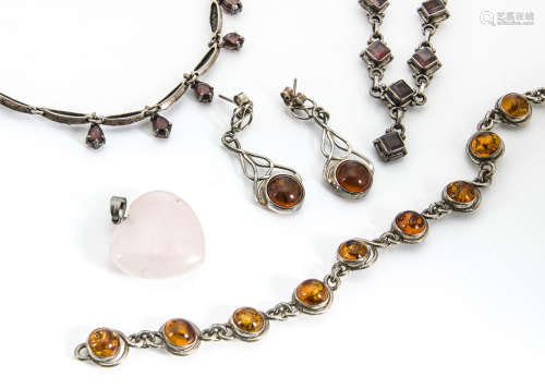 A small collection of amber and garnet set jewellery, including an amber bracelet and pair of