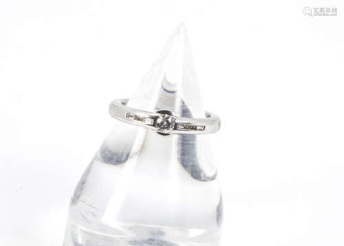 A modern 18ct white gold and diamond ring, having an approx 0.25ct old cut in rubbed over setting