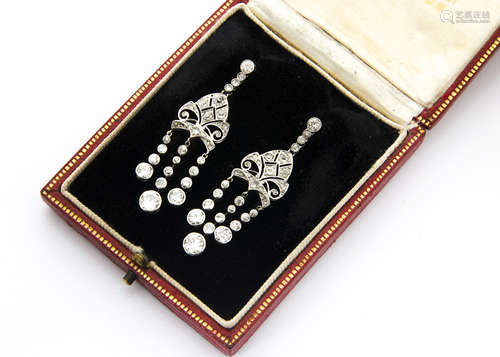 A pair of art deco diamond and platinum set drop earrings, the diamond set studs supporting a