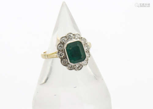 An emerald and diamond cluster ring, the 18ct gold cluster ring centred with an emerald cut stone