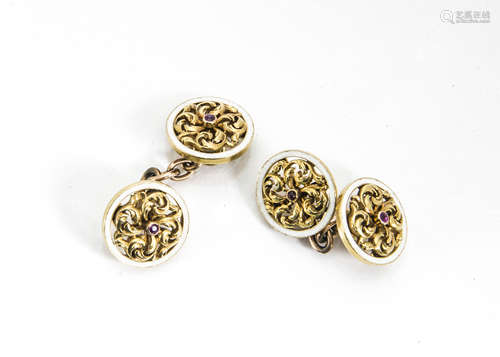 A pair of gold, enamel and ruby centred gentleman's cufflinks, the roundels with scroll settings