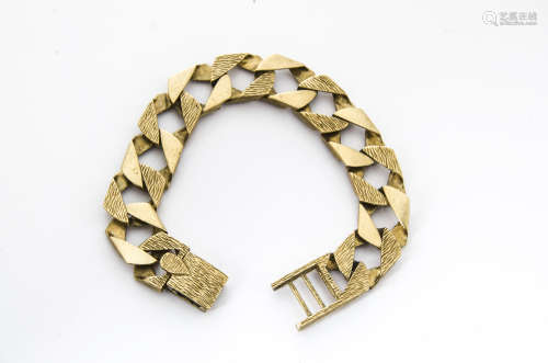 A 1980s 9ct gold gentleman's bracelet, having textured flattened links, hallmarked, 56g