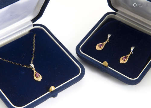 A contemporary 9ct gold ruby and diamond set pendant, with matching earrings in fitted case