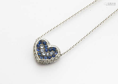 A contemporary diamond and sapphire heart shaped drop pendant, on an 18ct white gold oval linked