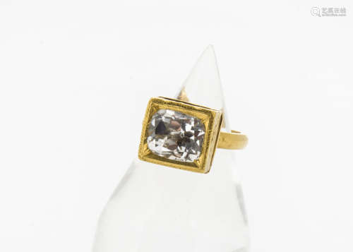 A 19th Century continental yellow metal topaz set ring, the cushion mixed cut within a raised square