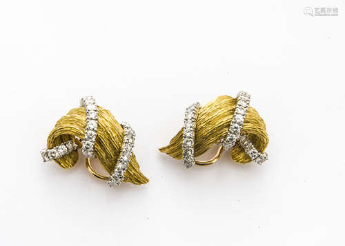 A pair of Kurt Wayne 18ct gold and diamond set ear clips, the textured scrolls with applied bands of