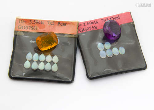 A collection of loose stones, including a cushion mixed cut fire opal, a synthetic colour change