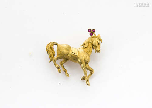 A continental 18ct gold ruby set horse brooch, modelled as a prancing horse with ruby plume to