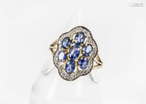 A modern 9ct gold sapphire and diamond cocktail dress ring, the shaped pierced tablet centred with
