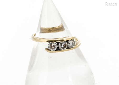 A three stone diamond crossover dress ring, the 0.75ct diamonds in channel setting, total diamond