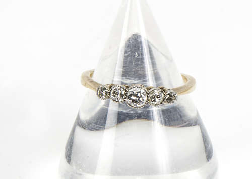 A 1920s five stone diamond ring, graduating transitional brilliant cuts in platinum settings on an