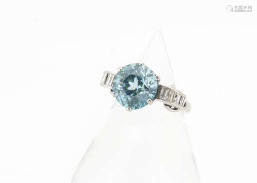 An art deco zircon and diamond dress ring, the circular mixed cut blue zircon in six claw setting
