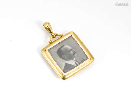 A 15ct gold square shaped open faced locket, with black and white portrait of a gentleman, total