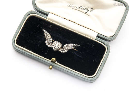 A pretty Victorian diamond set brooch, the gold and silver mount having central heart with wings and