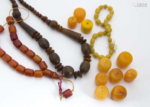 A quantity of amber style beads, including a middle eastern resin prayer bead string, a horn