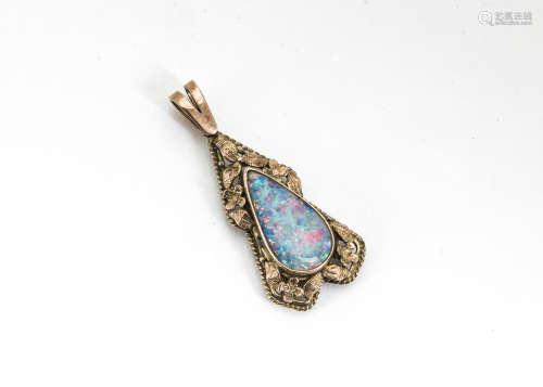 A black opal and gold pendant, the tear cut opal within a floral mount, total length 14cm x 1.6cm