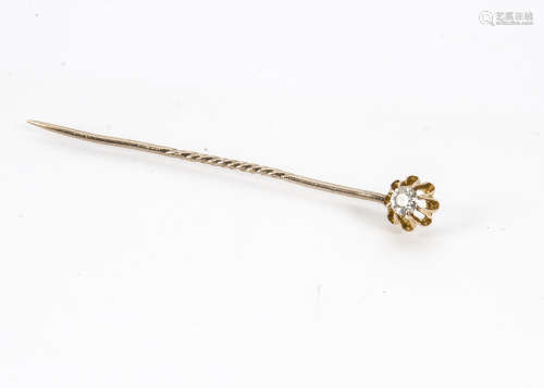 A Victorian gold and diamond stick pin, the claw set old cut in mount marked 15ct, pin possibly 9ct,